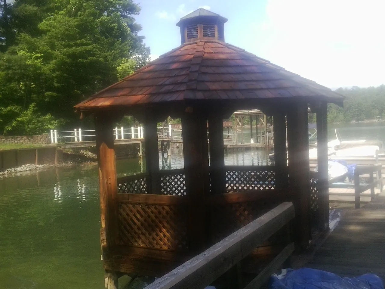 Cedar shake gazebo roof rebuilt on a lake dock in Crosby